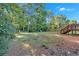 Sprawling backyard features a large grassy area, a storage shed, a wooden fence, and natural light at 54 Mildred Ct, Dallas, GA 30157