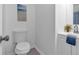 Clean bathroom featuring a toilet and modern vanity with a view of a plant and decorative painting at 54 Mildred Ct, Dallas, GA 30157