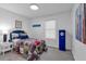 Comfortable bedroom featuring light gray wood flooring, decorated with baseball themed decor, and filled with natural light at 54 Mildred Ct, Dallas, GA 30157