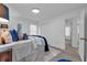 Bright bedroom showcasing light-colored walls and floor, a stylish bed, and easy access to other rooms at 54 Mildred Ct, Dallas, GA 30157