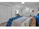 Comfortable bedroom with white walls, a bed featuring blue accents, and ample closet space at 54 Mildred Ct, Dallas, GA 30157