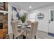 Cozy dining area with a glass-top table, upholstered chairs, and decorative artwork at 54 Mildred Ct, Dallas, GA 30157