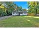 Quaint single-story home with well-maintained lawn, driveway, and mature trees at 54 Mildred Ct, Dallas, GA 30157