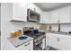 Well-equipped kitchen boasting granite counters, stainless steel appliances and white cabinets at 54 Mildred Ct, Dallas, GA 30157