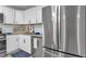 Updated kitchen featuring stainless steel appliances, white cabinets, and granite countertops at 54 Mildred Ct, Dallas, GA 30157