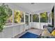 Relaxing screened porch featuring comfortable seating and views of the surrounding greenery at 54 Mildred Ct, Dallas, GA 30157