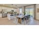 Bright open-concept dining area with modern decor adjacent to kitchen, ideal for everyday meals at 405 Newland Way, Acworth, GA 30102