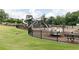 Neighborhood playground featuring modern play equipment, fenced for safety, and set within a grassy park area at 405 Newland Way, Acworth, GA 30102