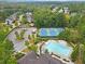 Aerial view of community amenities including a swimming pool, tennis courts, and parking at 6069 Queens River Dr, Mableton, GA 30126