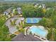 Aerial view of community amenities featuring a swimming pool, tennis courts, and ample parking at 6069 Queens River Dr, Mableton, GA 30126