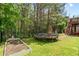 Landscaped backyard with a trampoline and garden at 6069 Queens River Dr, Mableton, GA 30126