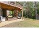 Backyard with a partially covered patio, a sandbox, and a wooden staircase at 6069 Queens River Dr, Mableton, GA 30126
