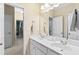 Bright bathroom featuring double sink vanity with white cabinets and large mirror at 6069 Queens River Dr, Mableton, GA 30126