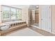 Bright bathroom with a soaking tub, walk in shower, and natural light at 6069 Queens River Dr, Mableton, GA 30126