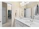 Bright bathroom featuring a double sink vanity with white cabinets and chrome fixtures at 6069 Queens River Dr, Mableton, GA 30126