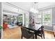 Open-concept dining room with large table, a modern chandelier, and view to a living room at 6069 Queens River Dr, Mableton, GA 30126