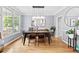 Elegant dining room featuring a modern light fixture, large window, and stylish decor at 6069 Queens River Dr, Mableton, GA 30126