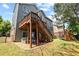 Home exterior showcasing an outdoor deck with stairs, a spacious yard with activities at 6069 Queens River Dr, Mableton, GA 30126