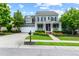 Charming two-story home with a well-manicured lawn, flower beds, and attached two-car garage at 6069 Queens River Dr, Mableton, GA 30126