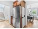 Hallway view featuring stainless refrigerator, staircase and a view to the dining room at 6069 Queens River Dr, Mableton, GA 30126
