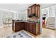 Spacious kitchen with granite countertops, wooden cabinets, and access to breakfast nook at 6069 Queens River Dr, Mableton, GA 30126