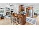 Kitchen with granite counters, bar seating, wooden cabinets, and a view to the living room at 6069 Queens River Dr, Mableton, GA 30126