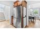 An open kitchen area that has stainless steel appliances, hardwood floors, and access to the staircase at 6069 Queens River Dr, Mableton, GA 30126