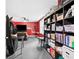 Bright living room features a bookcase, tv and a cozy sofa at 6069 Queens River Dr, Mableton, GA 30126