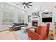 Bright living room with a fireplace, built-in shelves, hardwood floors and large windows at 6069 Queens River Dr, Mableton, GA 30126