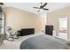 Relaxing main bedroom with a ceiling fan, rocking chair, and access to an ensuite bathroom, creating a serene retreat at 6069 Queens River Dr, Mableton, GA 30126