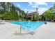 A large community pool is surrounded by green trees and a clubhouse for residents at 6069 Queens River Dr, Mableton, GA 30126