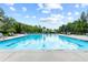 Community pool with sparkling water, lounge chairs, and clear blue skies above at 6069 Queens River Dr, Mableton, GA 30126