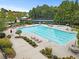 Aerial view of the community pool with lounge chairs and landscaping at 6069 Queens River Dr, Mableton, GA 30126