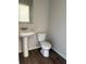 Half bathroom featuring hardwood floors and a pedestal sink at 6446 Grey Fox Way, Riverdale, GA 30296