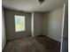 Carpeted bedroom with a window at 6446 Grey Fox Way, Riverdale, GA 30296