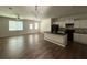 Open concept living area featuring wood floors, a kitchen island, and natural light at 6446 Grey Fox Way, Riverdale, GA 30296