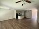 Spacious living room features a kitchen island and modern ceiling fan at 6446 Grey Fox Way, Riverdale, GA 30296