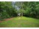 Private backyard with mature trees and a fire pit area for outdoor enjoyment at 670 Parker Ave, Decatur, GA 30032