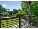 Balcony view featuring a green lawn, lush trees, and neighborhood houses at 670 Parker Ave, Decatur, GA 30032