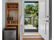 Small bar with mini fridge and outdoor view of home's back deck and landscape at 670 Parker Ave, Decatur, GA 30032
