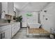Spa-like bathroom with a soaking tub, sleek vanity, glass shower and modern fixtures at 670 Parker Ave, Decatur, GA 30032