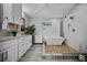 Spa-like bathroom boasts a soaking tub, walk-in shower, double vanity, and modern finishes at 670 Parker Ave, Decatur, GA 30032