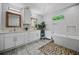 Luxurious bathroom with double vanity, soaking tub, and stylish tile work throughout the space at 670 Parker Ave, Decatur, GA 30032