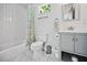 Well-lit bathroom featuring modern fixtures, subway tile shower and marble floors at 670 Parker Ave, Decatur, GA 30032