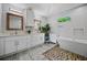 Modern bathroom with double vanity, white cabinets, stylish fixtures, and soaking tub at 670 Parker Ave, Decatur, GA 30032