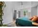 Bright bedroom features a ceiling fan, wood floors, and ample closet space at 670 Parker Ave, Decatur, GA 30032