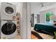 Clean bedroom with stackable washer/dryer, neutral paint, and window views at 670 Parker Ave, Decatur, GA 30032