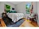 Comfortable bedroom with natural light, wood floors, and neutral decor at 670 Parker Ave, Decatur, GA 30032