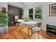 Bright dining room features hardwood floors, modern lighting, and large windows offering a serene view at 670 Parker Ave, Decatur, GA 30032