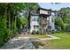 Modern two-story home with a rooftop deck, a second story balcony, neutral siding, and a concrete driveway at 670 Parker Ave, Decatur, GA 30032